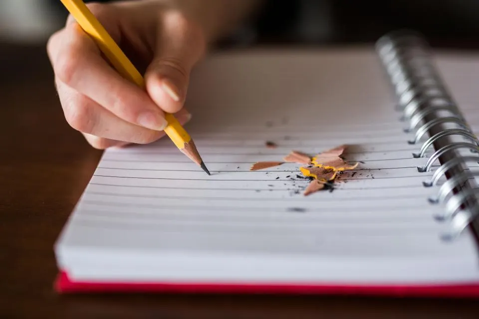 Notebook and pencil beside a written plan